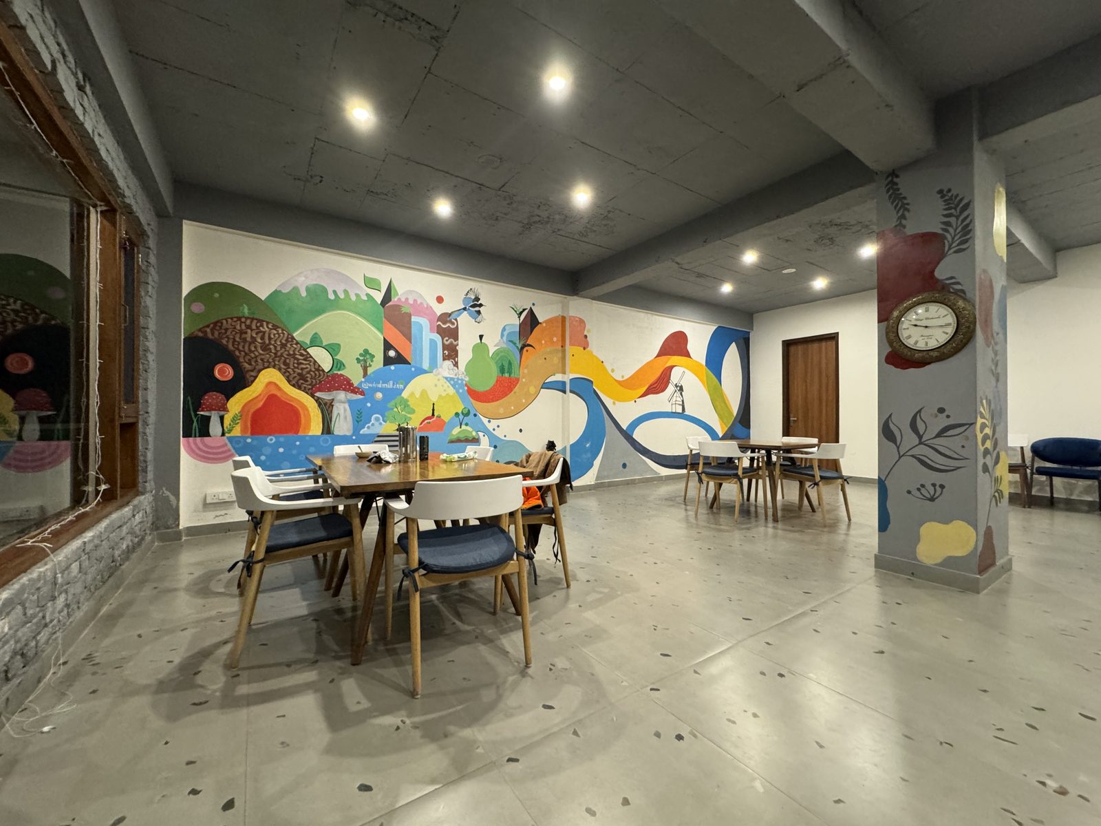 The Windmill Inn café with a colourful hand-painted mural across the back wall